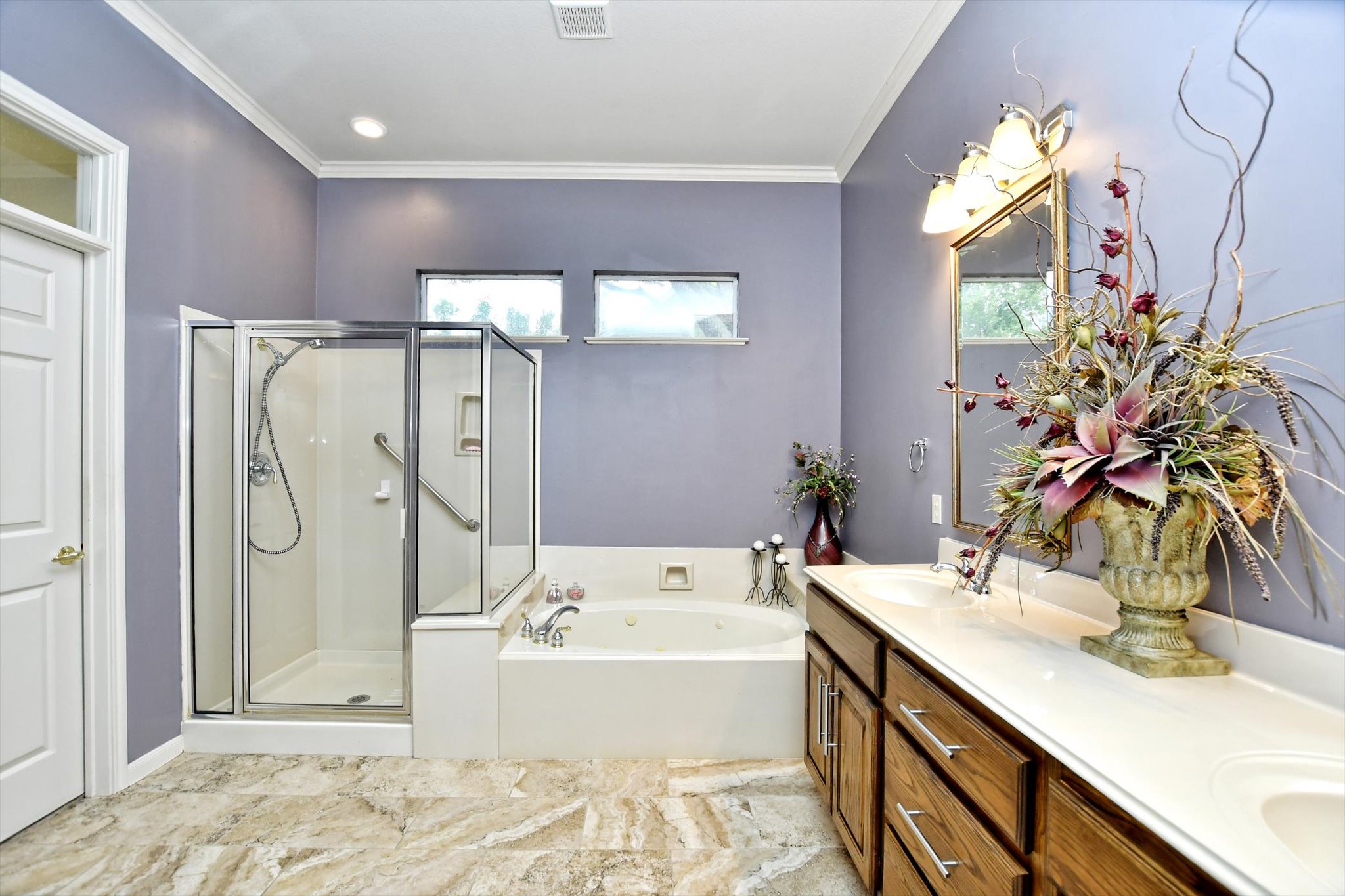 106 Nighthawk Way Georgetown, TX 78633 - Photo 16 of 29 Luxurious bathing quarters feature a spacious walk-in shower and a jetted soaking tub.