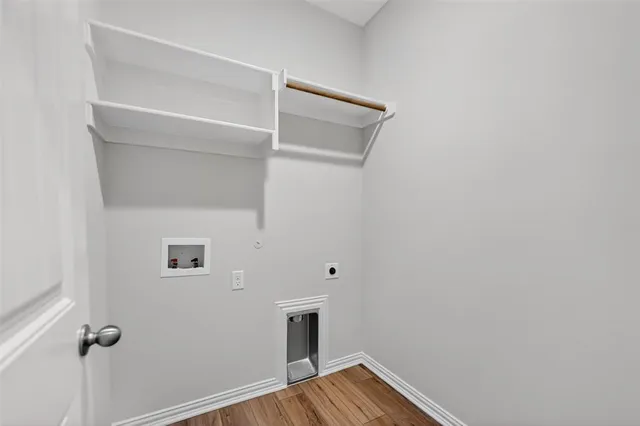 a view of a room with wooden floor