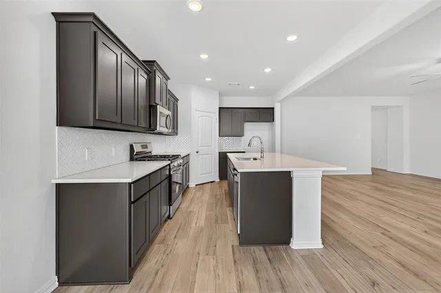 a kitchen with a sink and cabinets