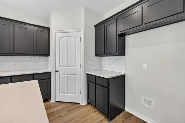 a kitchen with a refrigerator and cabinets