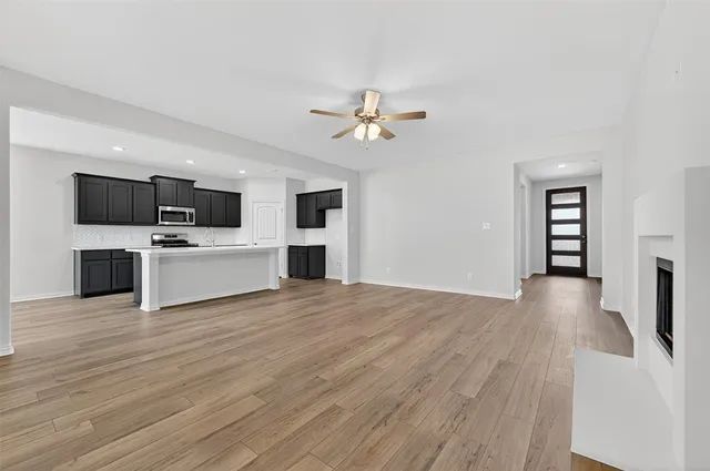 a view of a kitchen with a sink microwave and a stove