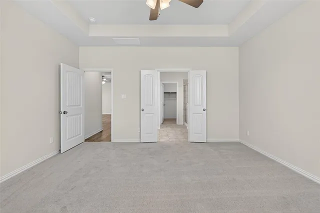 an empty room with fan and entrance