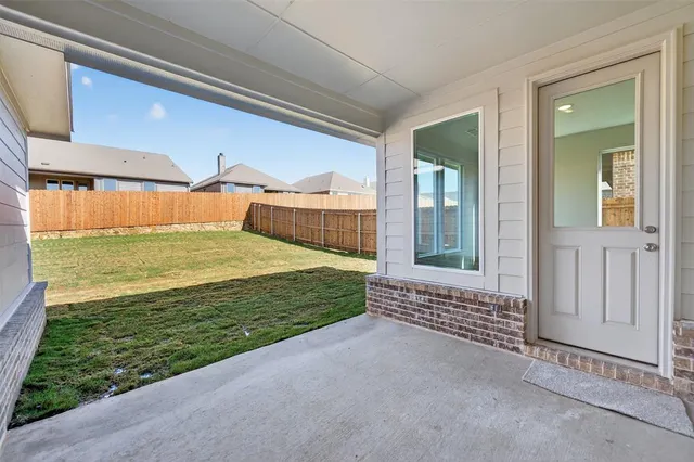 a view of a porch with a floor to ceiling window and a yard