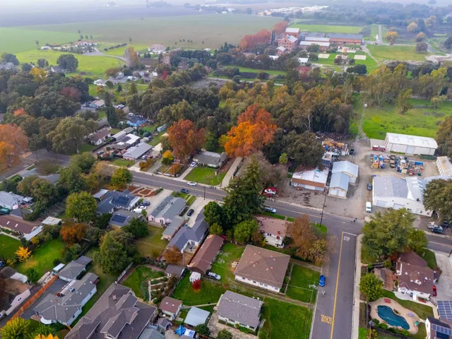 an aerial view of residential houses with outdoor space and river