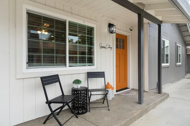 a view of a house with backyard and sitting area