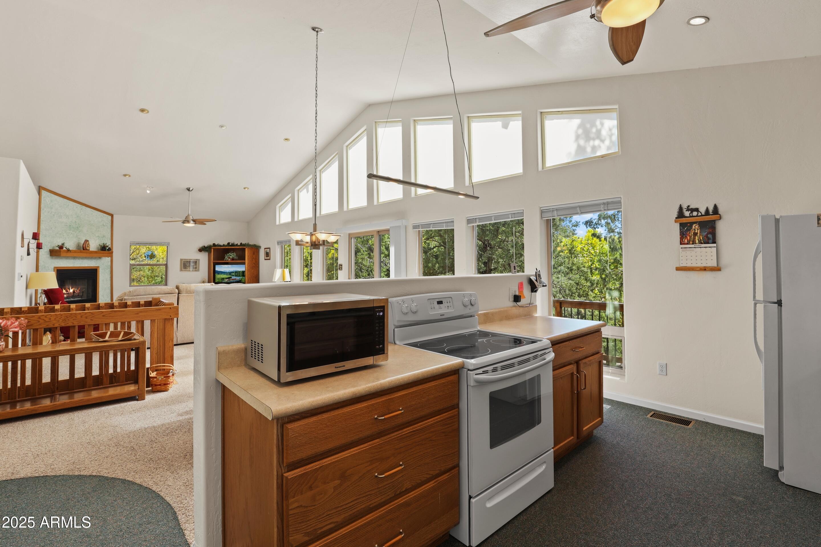 989 Verde Road Payson, AZ 85541 - Photo 16 of 44 a kitchen with a stove and a white cabinets