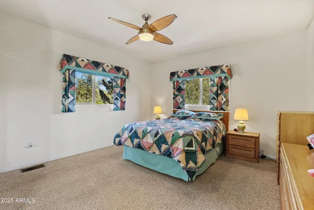 a bed sitting in a bedroom next to a cabinet