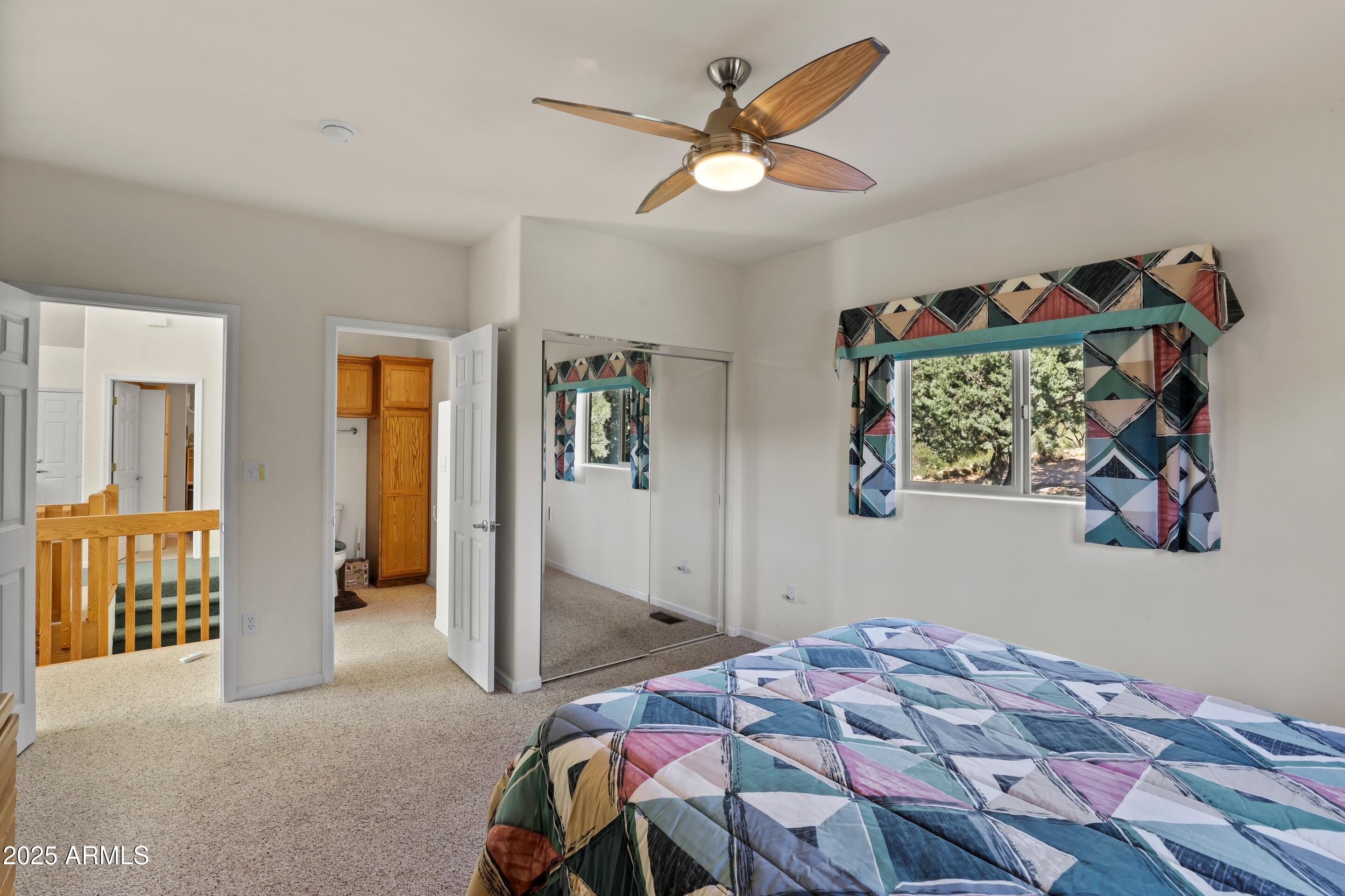 989 Verde Road Payson, AZ 85541 - Photo 19 of 44 a bedroom with a bed and a chandelier