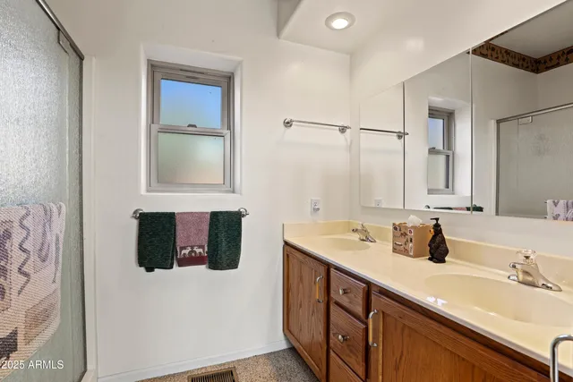 a bathroom with a sink double vanity and a mirror
