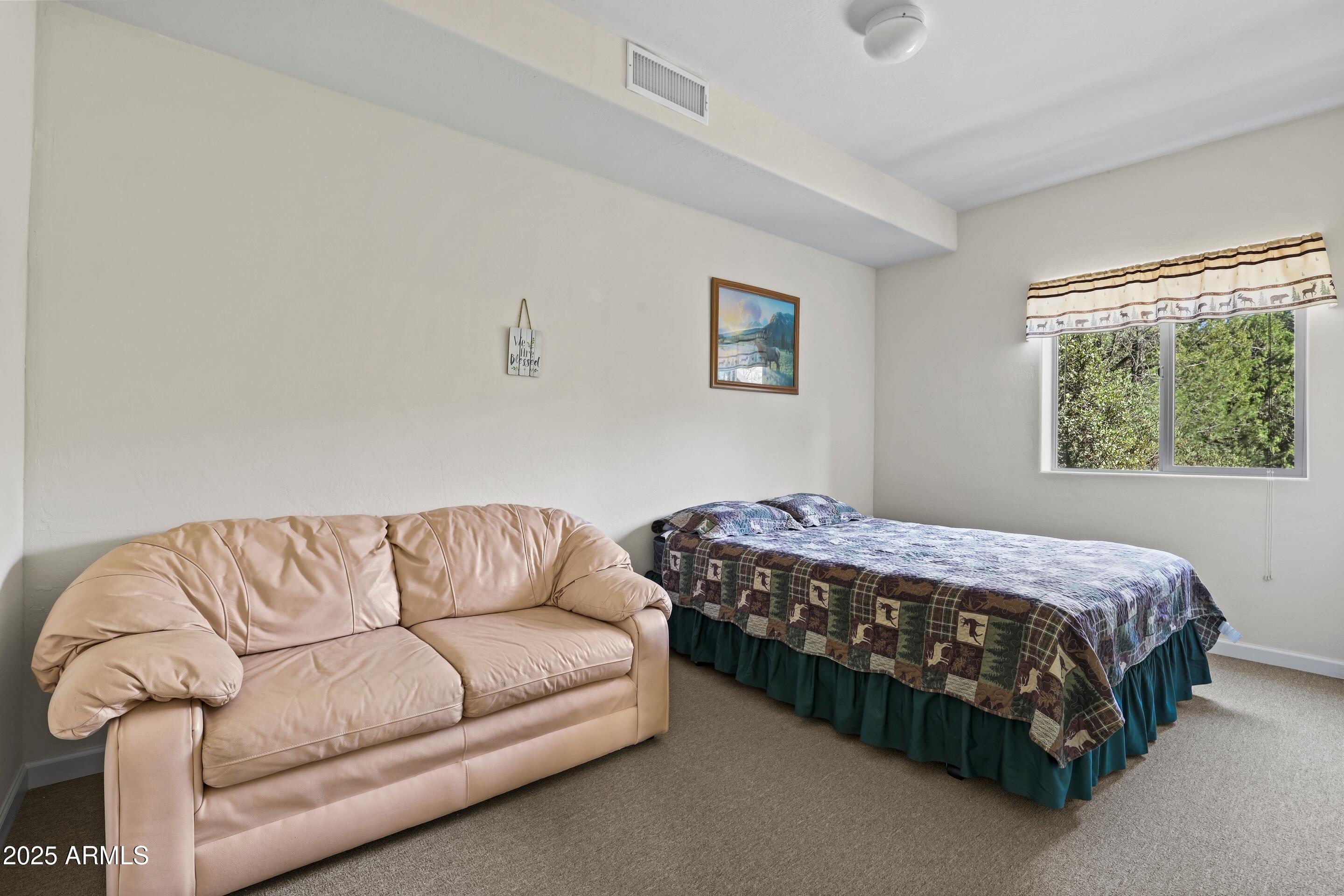 989 Verde Road Payson, AZ 85541 - Photo 26 of 44 a bedroom with a bed couch and window