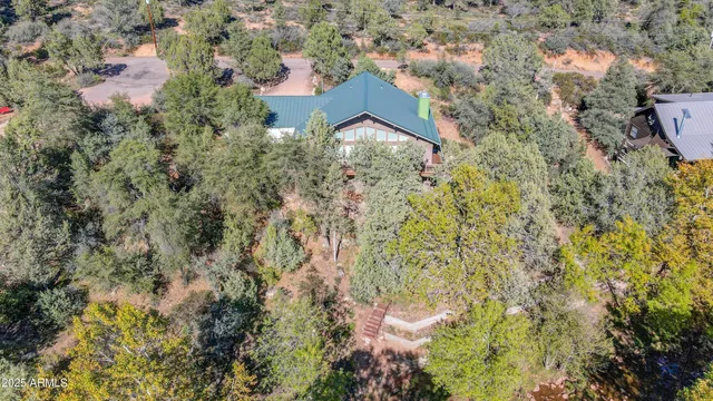 an aerial view of house with yard and swimming pool