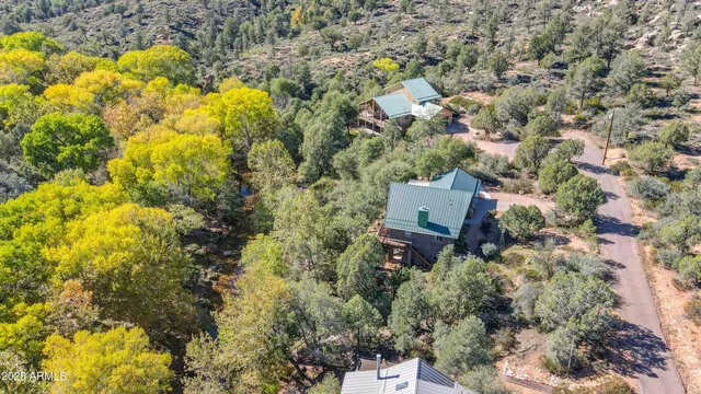 an aerial view of residential house with swimming pool and green space