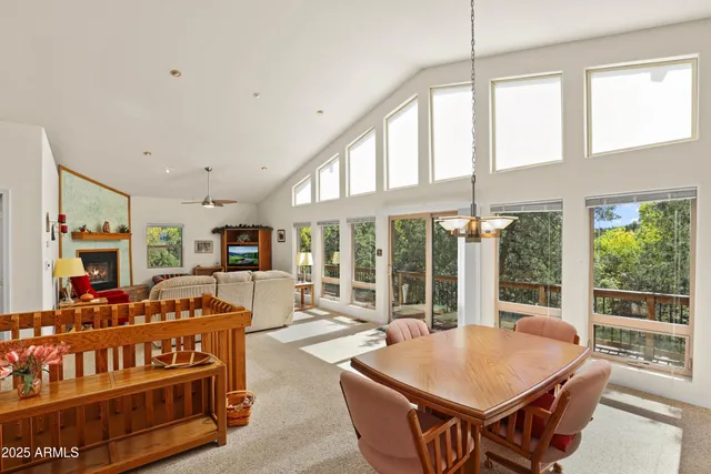 a living room with furniture a table and chairs