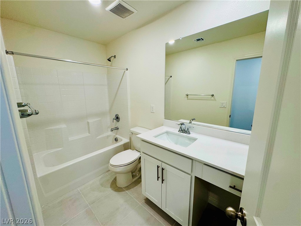 9249 Innot Avenue Las Vegas, NV 89148 - Photo 12 of 24 A well-appointed bathroom features a crisp white vanity and a practical tub-shower combination.