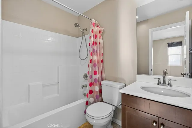 a bathroom with a sink a toilet and a shower curtain