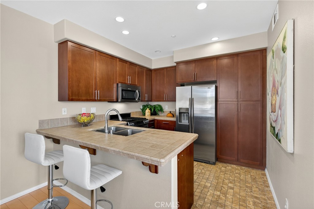 942 South 4th Street Montebello, CA 90640 - Photo 9 of 20 a kitchen with stainless steel appliances granite countertop a refrigerator a stove top oven a sink and dishwasher