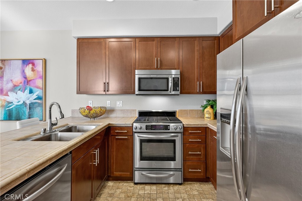 942 South 4th Street Montebello, CA 90640 - Photo 10 of 20 a kitchen with a sink stove and microwave