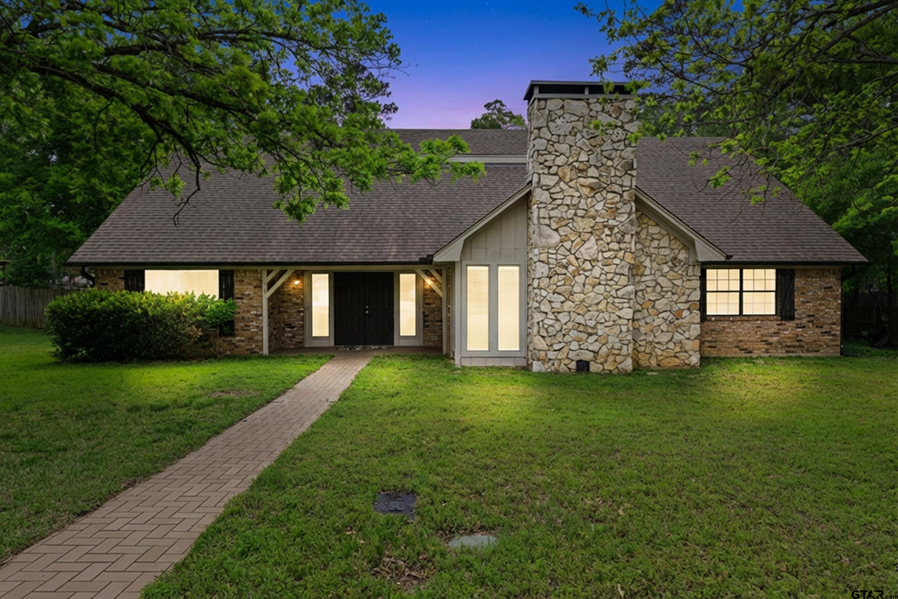 a front view of a house with a garden