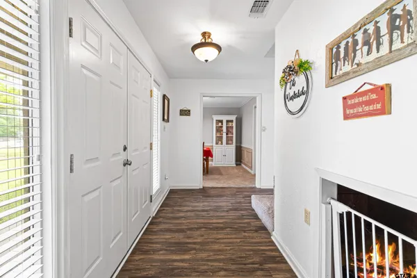 a view of a hallway to a livingroom with furniture