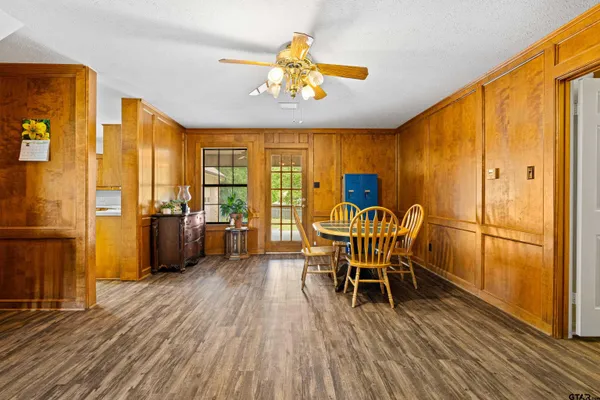 a dining room with furniture entryway and wooden floor