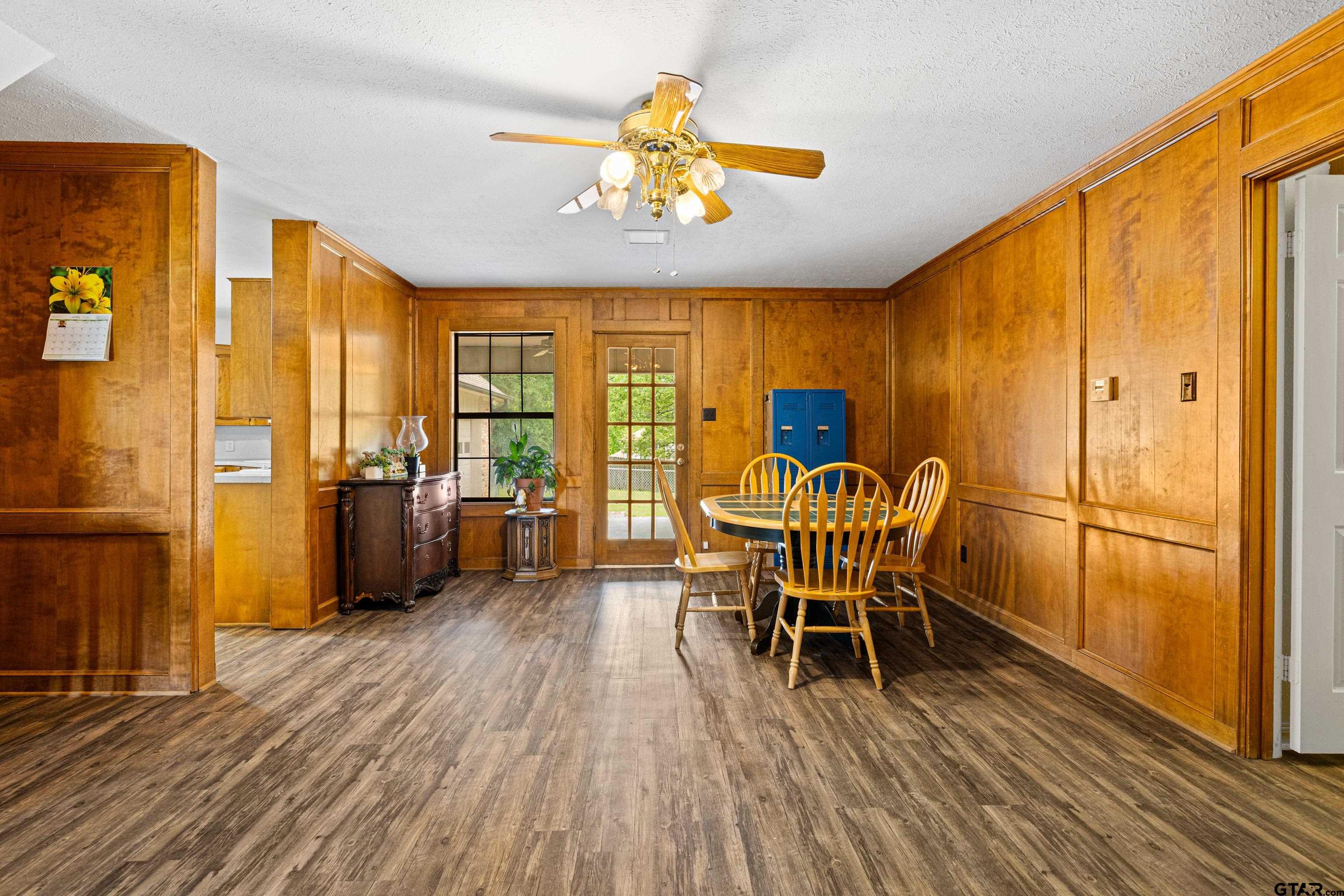 1810 Azalea Street Gilmer, TX 75644 - Photo 13 of 47 a dining room with furniture entryway and wooden floor