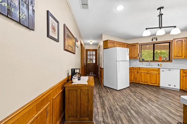 a kitchen with refrigerator and microwave