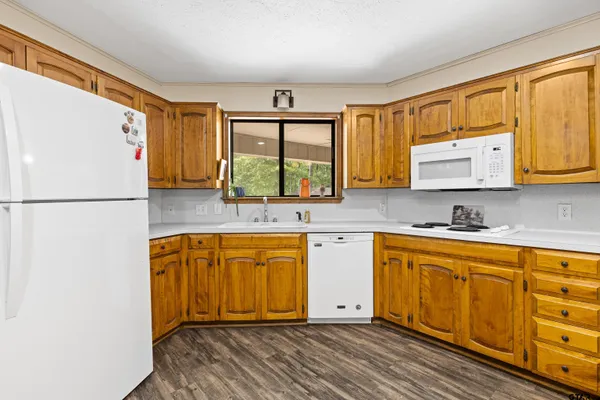 a kitchen with stainless steel appliances granite countertop a refrigerator sink and cabinets