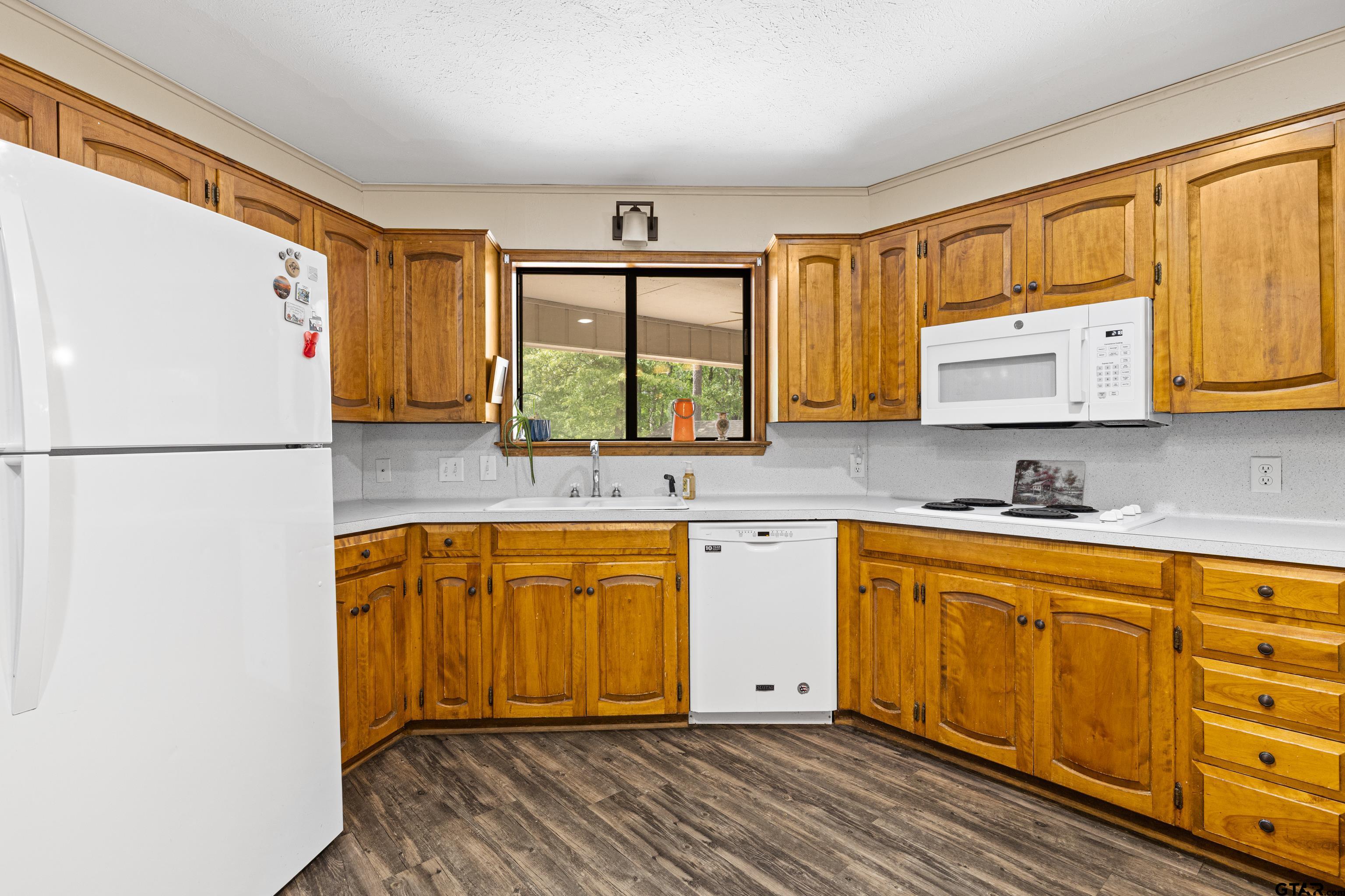 1810 Azalea Street Gilmer, TX 75644 - Photo 19 of 47 a kitchen with stainless steel appliances granite countertop a refrigerator sink and cabinets
