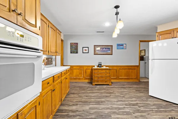 a view of a bathroom with wooden floor and a ceiling fan