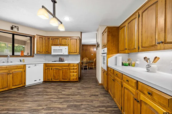 a kitchen with stainless steel appliances wooden cabinets a sink and a stove