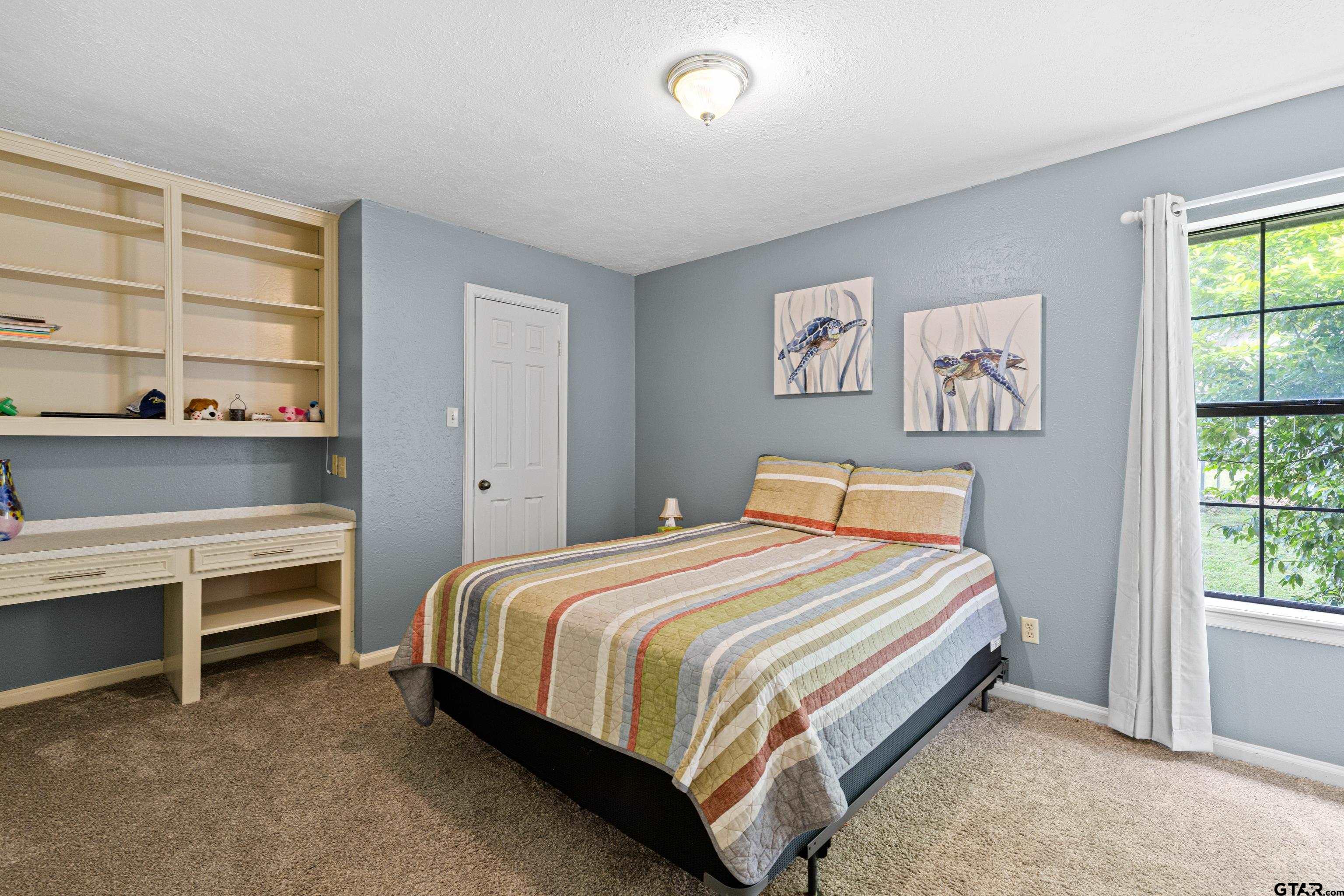 1810 Azalea Street Gilmer, TX 75644 - Photo 31 of 47 a bedroom with a bed and a window