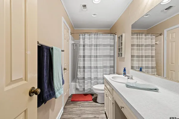 a bathroom with a sink a vanity and a tub