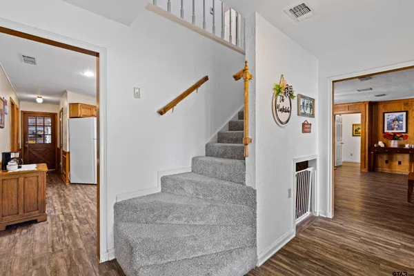 a view of entryway and hall with wooden floor
