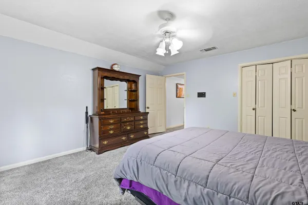 a bedroom with a bed and a dresser