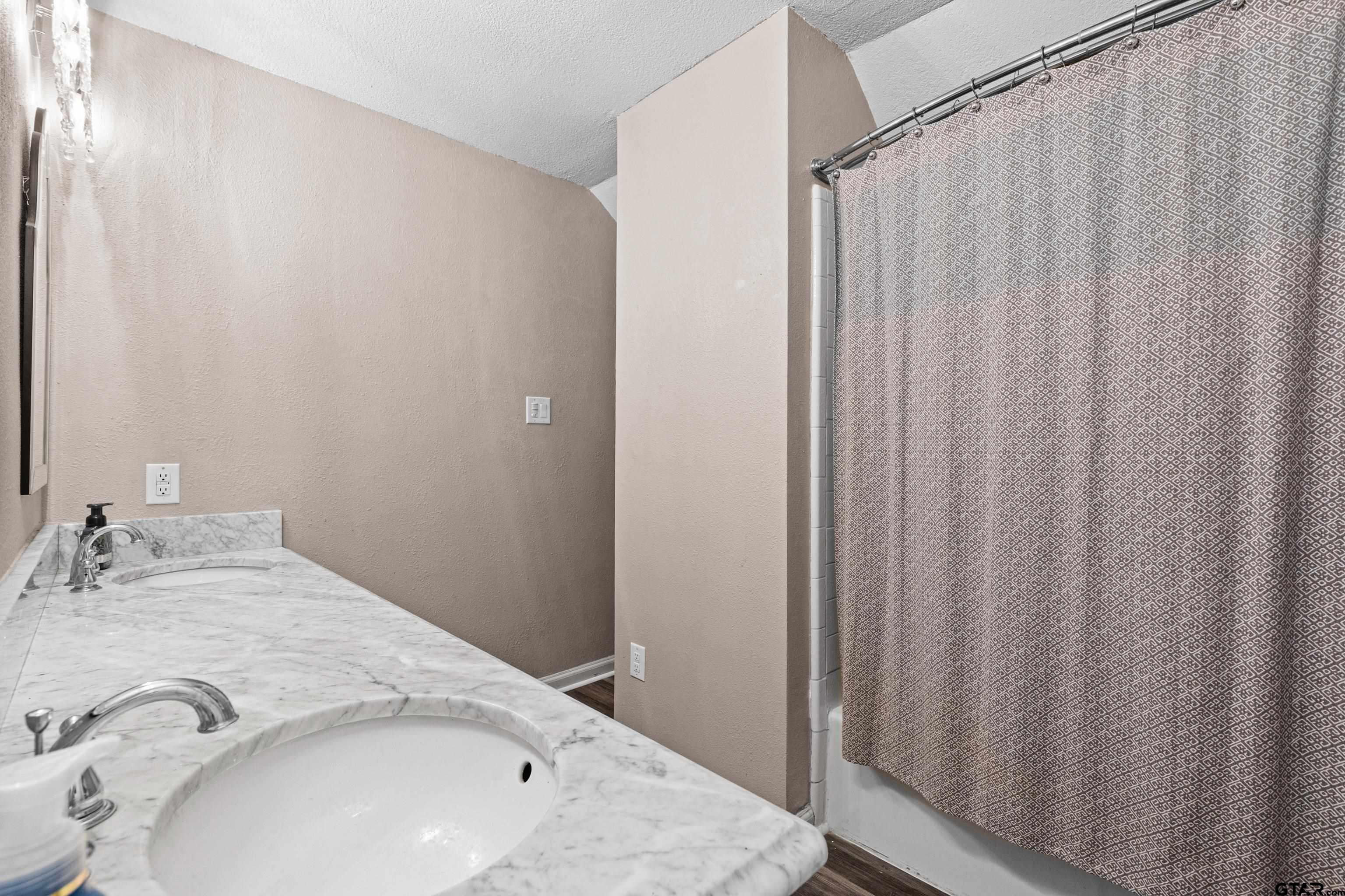 1810 Azalea Street Gilmer, TX 75644 - Photo 40 of 47 a bathroom with a sink and a mirror