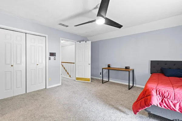 a bedroom with a bed and a dresser