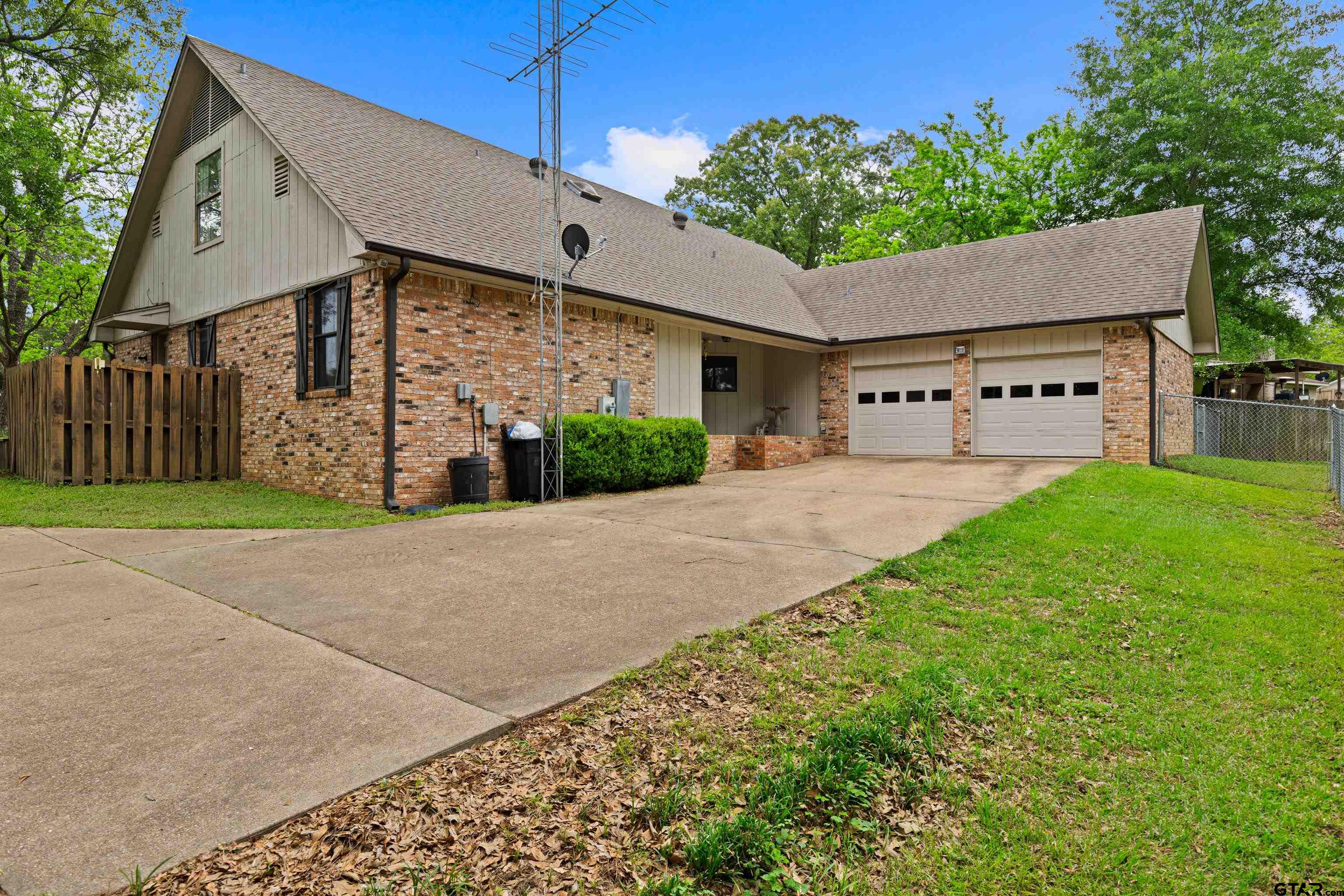 1810 Azalea Street Gilmer, TX 75644 - Photo 47 of 47 a front view of a house with garden