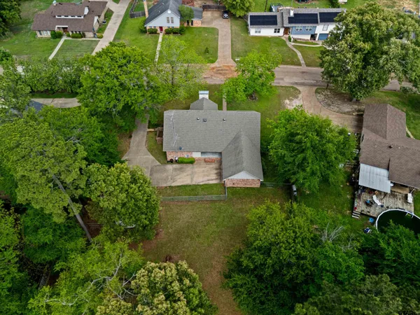 an aerial view of a house with outdoor space