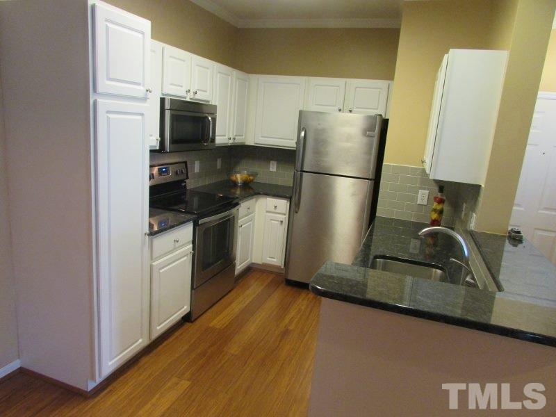 710 North Person Street, Unit 207 Raleigh, NC 27604 - Photo 5 of 12 a kitchen with a sink appliances and cabinets