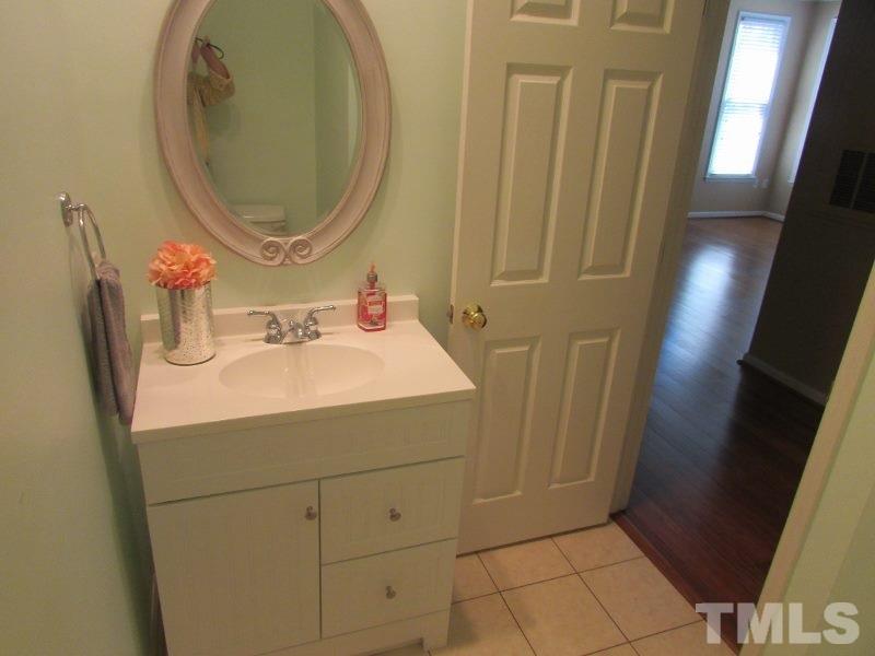 710 North Person Street, Unit 207 Raleigh, NC 27604 - Photo 8 of 12 a bathroom with a sink a toilet and a mirror