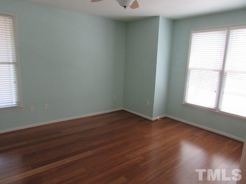 710 North Person Street, Unit 207 Raleigh, NC 27604 - Photo 9 of 12 an empty room with wooden floor and windows