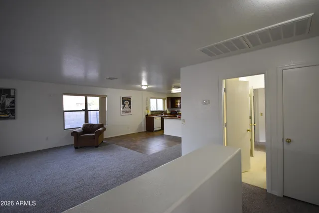 a view of a livingroom with furniture wooden floor and a window