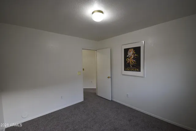 an empty room with wall painting and windows