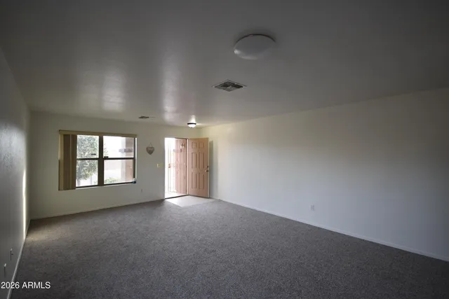 an empty room with a empty space and windows