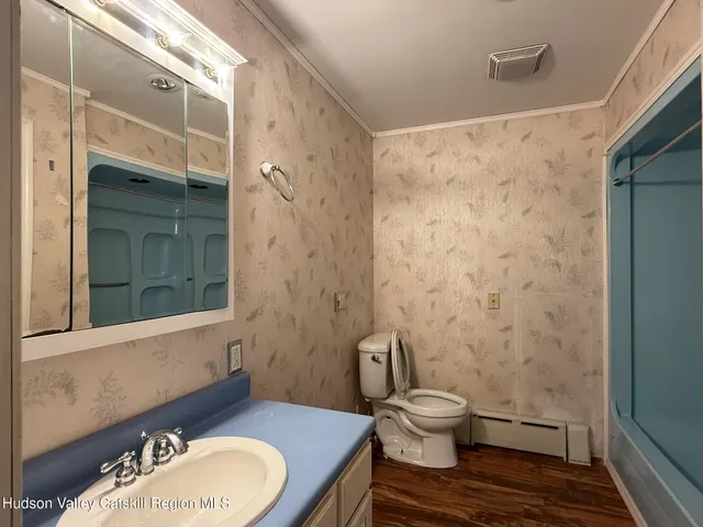 a kitchen with a sink a stove a refrigerator and white cabinets