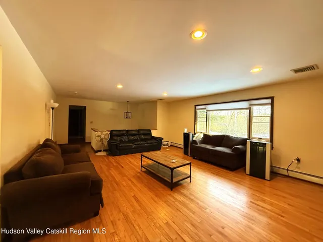 a view of a dining room with furniture and wooden floor