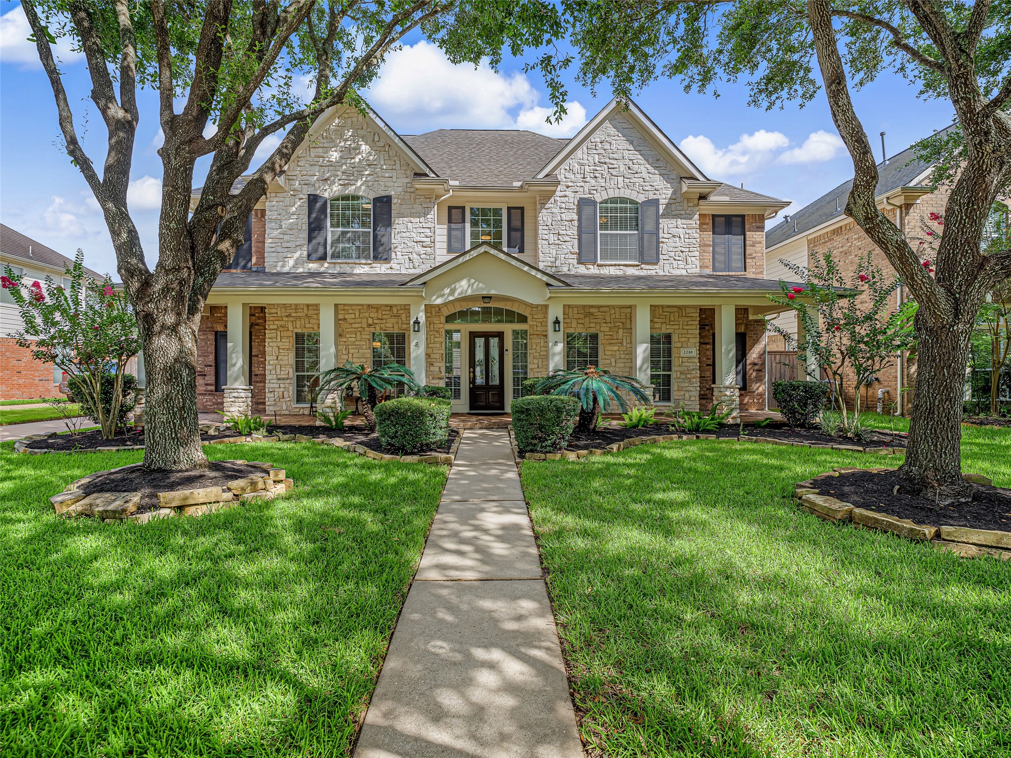 2210 Fox Path Katy, TX 77494 - Photo 1 of 47 Nestled in the highly desirable master-planned community of Grayson Lakes, this stunning two-story traditional home perfectly blends timeless southern charm with modern elegance.