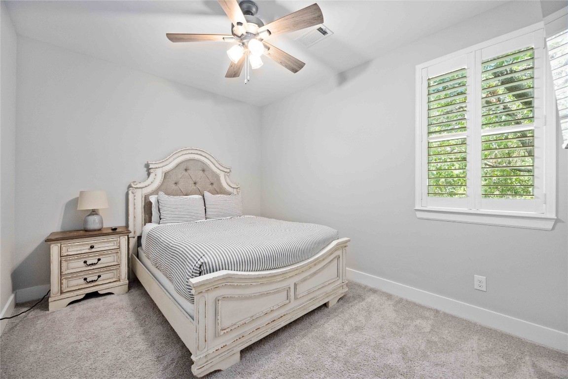 1324 West Pierce Street Houston, TX 77019 - Photo 24 of 26 a bed sitting in a bedroom next to a window