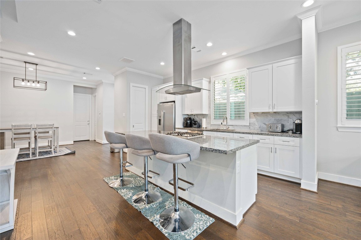 1324 West Pierce Street Houston, TX 77019 - Photo 8 of 26 a kitchen with stainless steel appliances granite countertop a stove and white cabinets