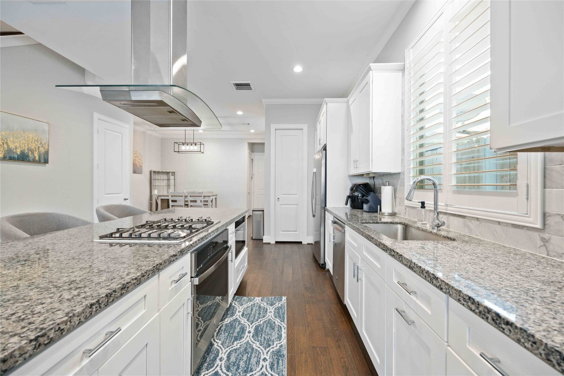 1324 West Pierce Street Houston, TX 77019 - Photo 9 of 26 a kitchen with stainless steel appliances granite countertop a sink stove and cabinets